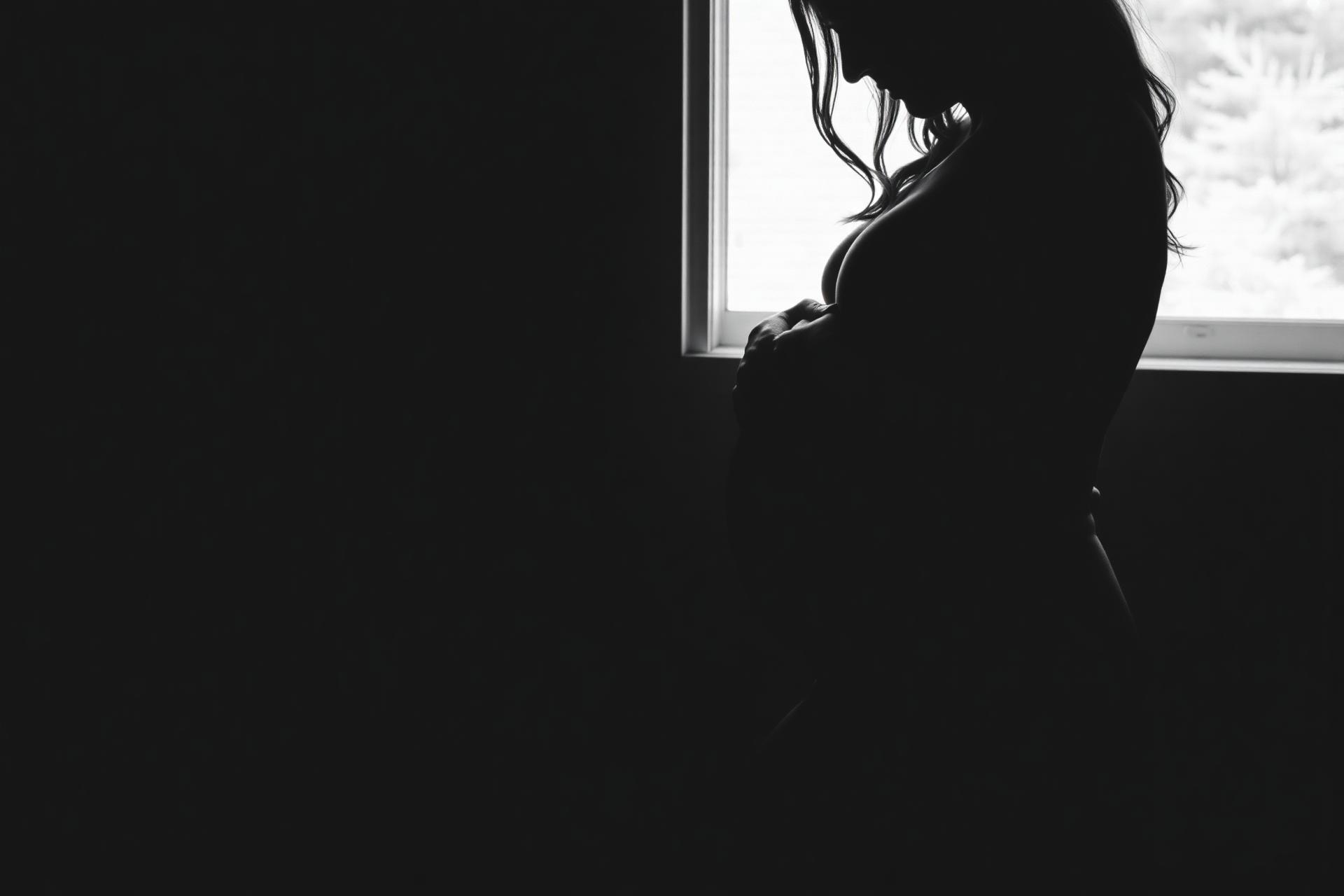 Expectant mother in soft window light